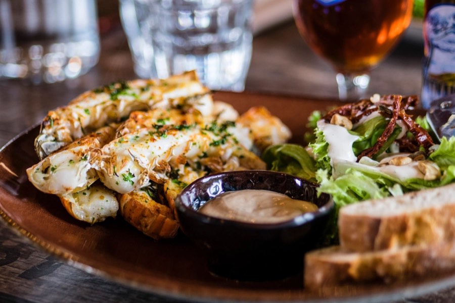 A platter of seafood and grilled fish served on a wooden board